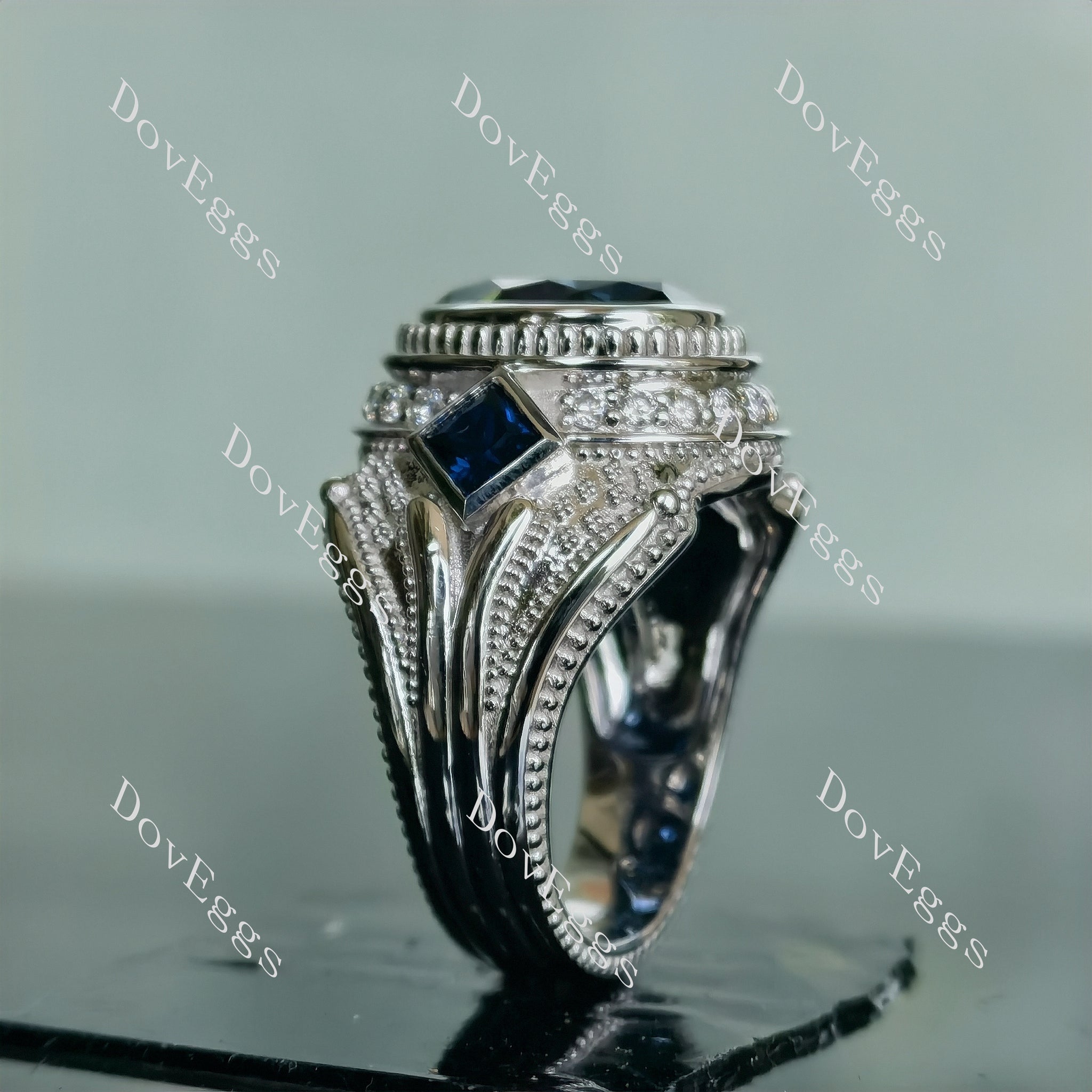 The Trinity oval bezel twilight blue moissanite engagement ring
