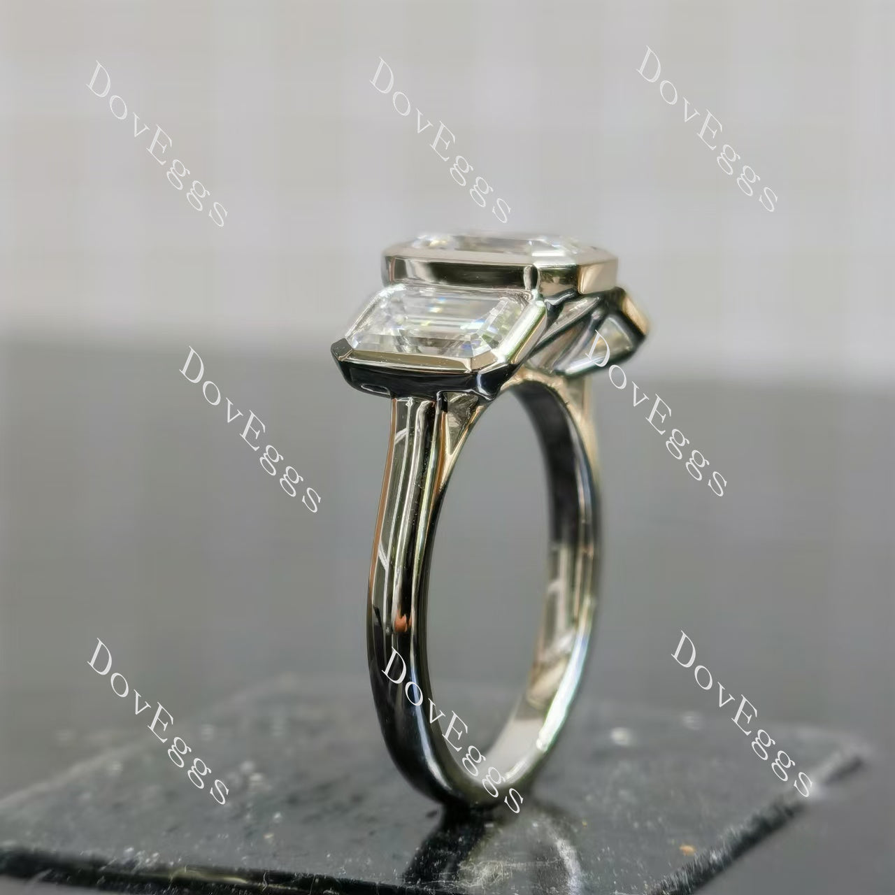 Doveggs emerald/elongated emerald bezel three stones moissanite engagement ring