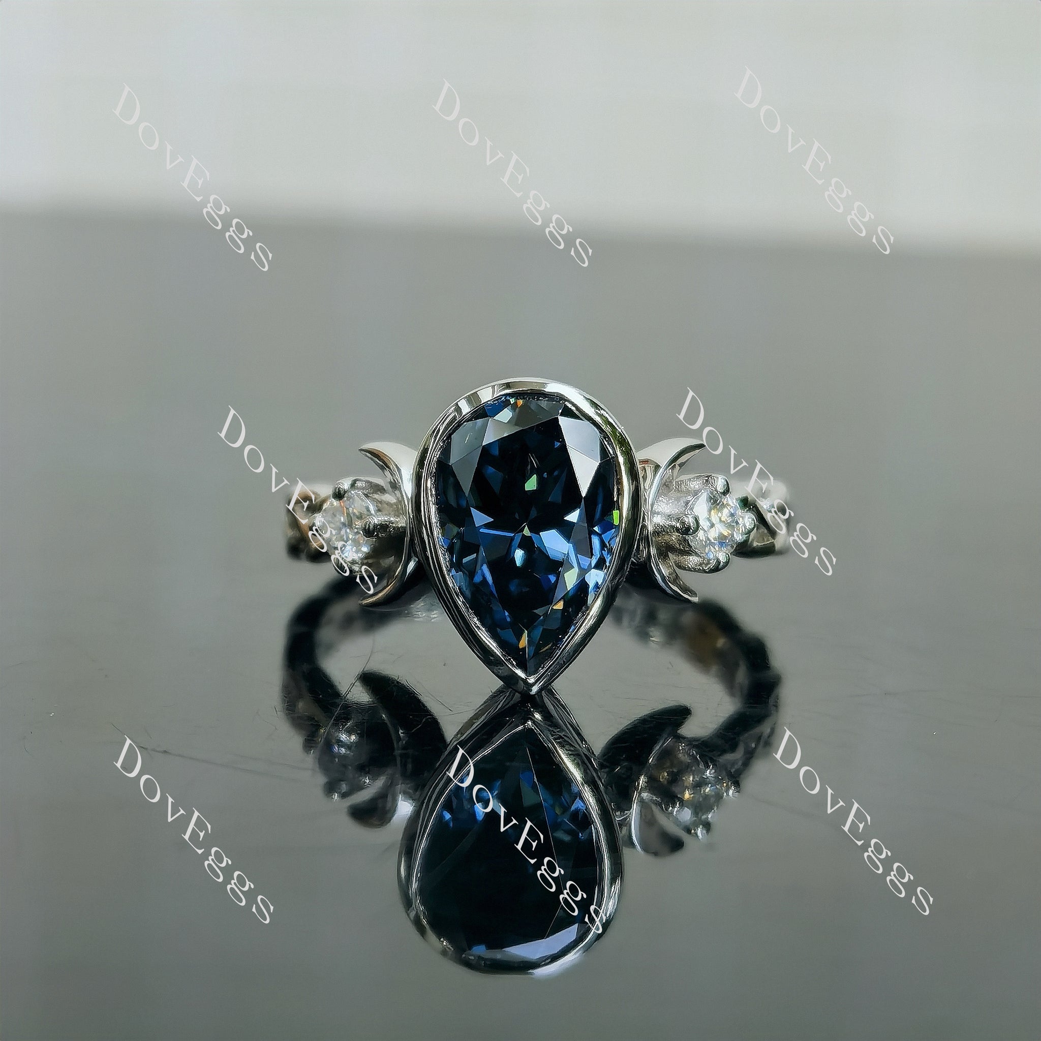 Doveggs pear twilight blue half moon three-stone moissanite engagement ring