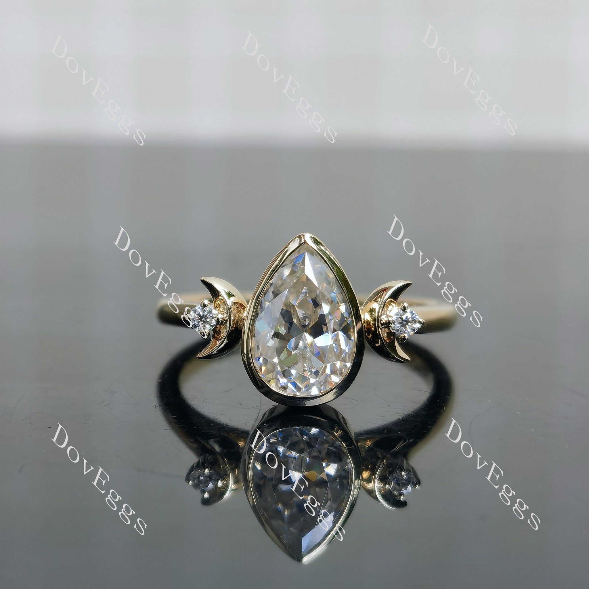 Moon Maiden pear bezel half moon three-stone moissanite engagement ring