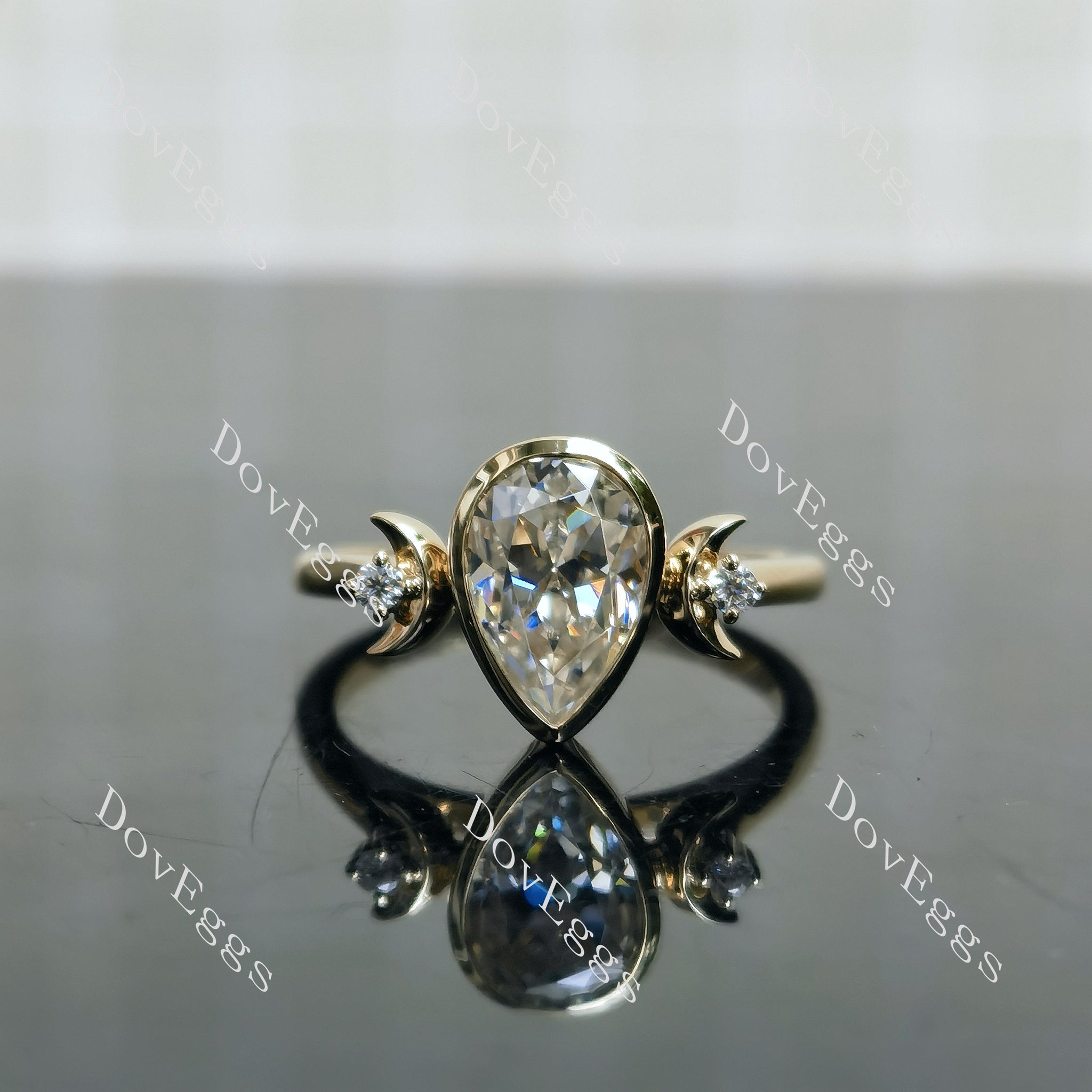 Moon Maiden pear bezel half moon three-stone moissanite engagement ring