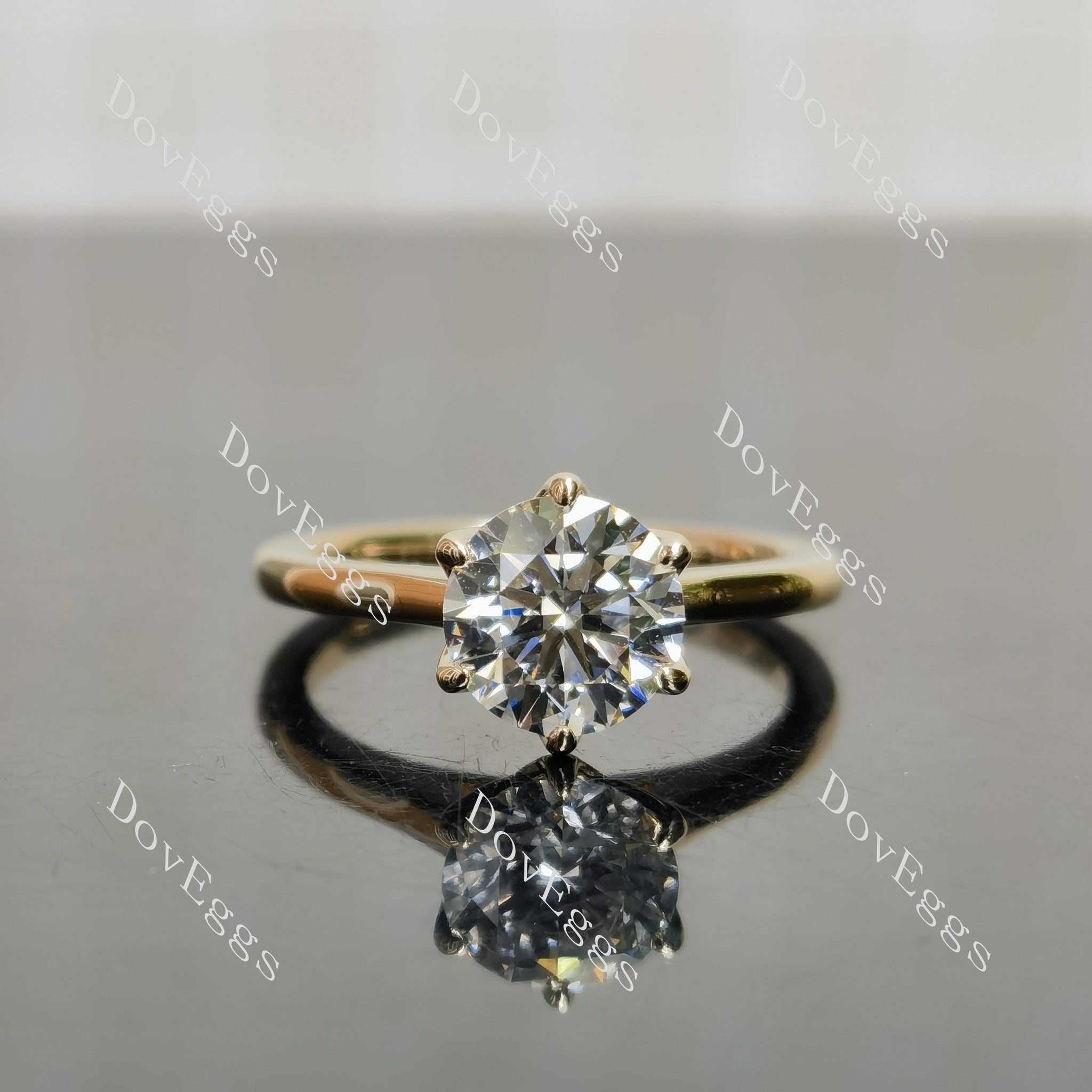 A close-up view of the round moissanite center stone in the engagement ring, showcasing its sparkling brilliance.|DovEggs 