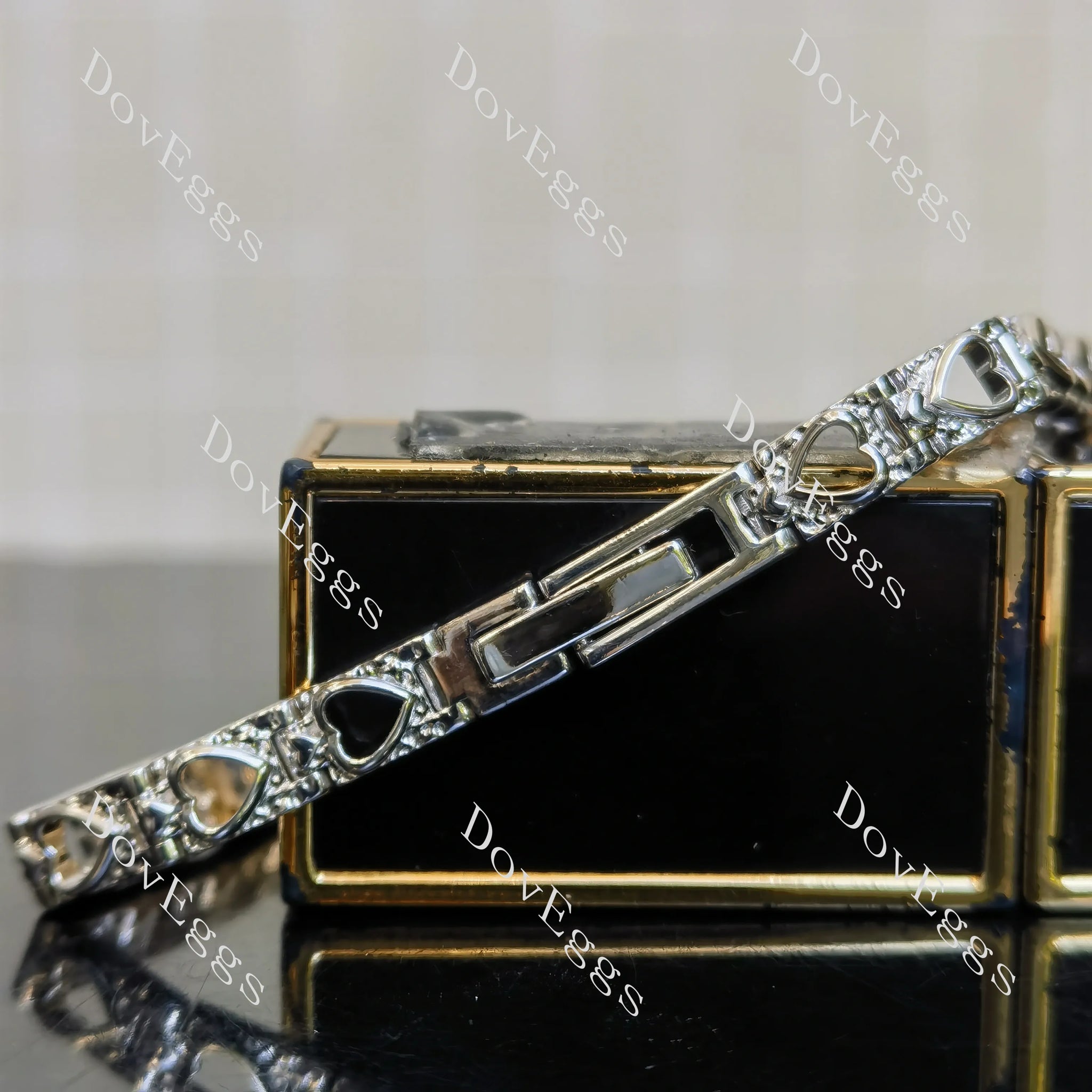 Details of the heart shaped hollow out heart moissanite bracelet's buckle.