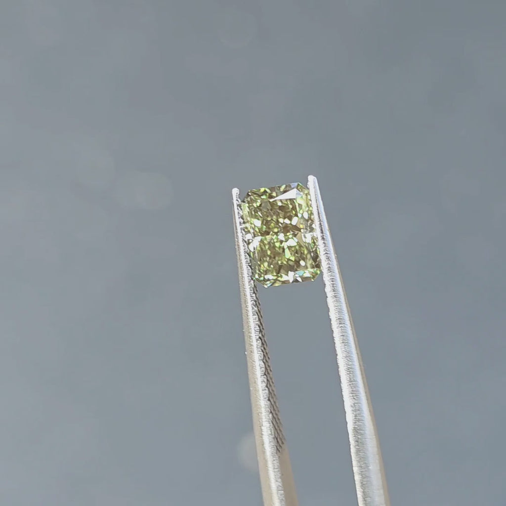 1.27ct radiant cut fancy vivid green VVS1 lab diamond showing intense color in outdoor sunlight.