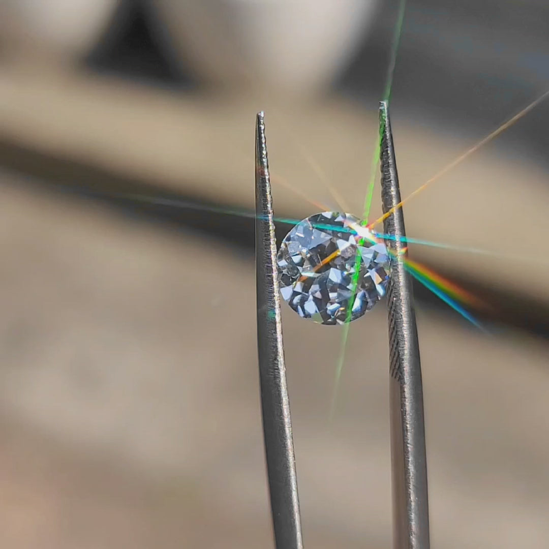 2.01ct round brilliant lab diamond (E/VVS1) outdoors, displaying maximum sparkle