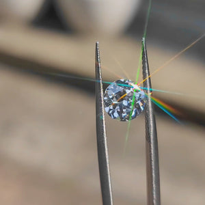 2.01ct round brilliant lab diamond (E/VVS1) outdoors, displaying maximum sparkle