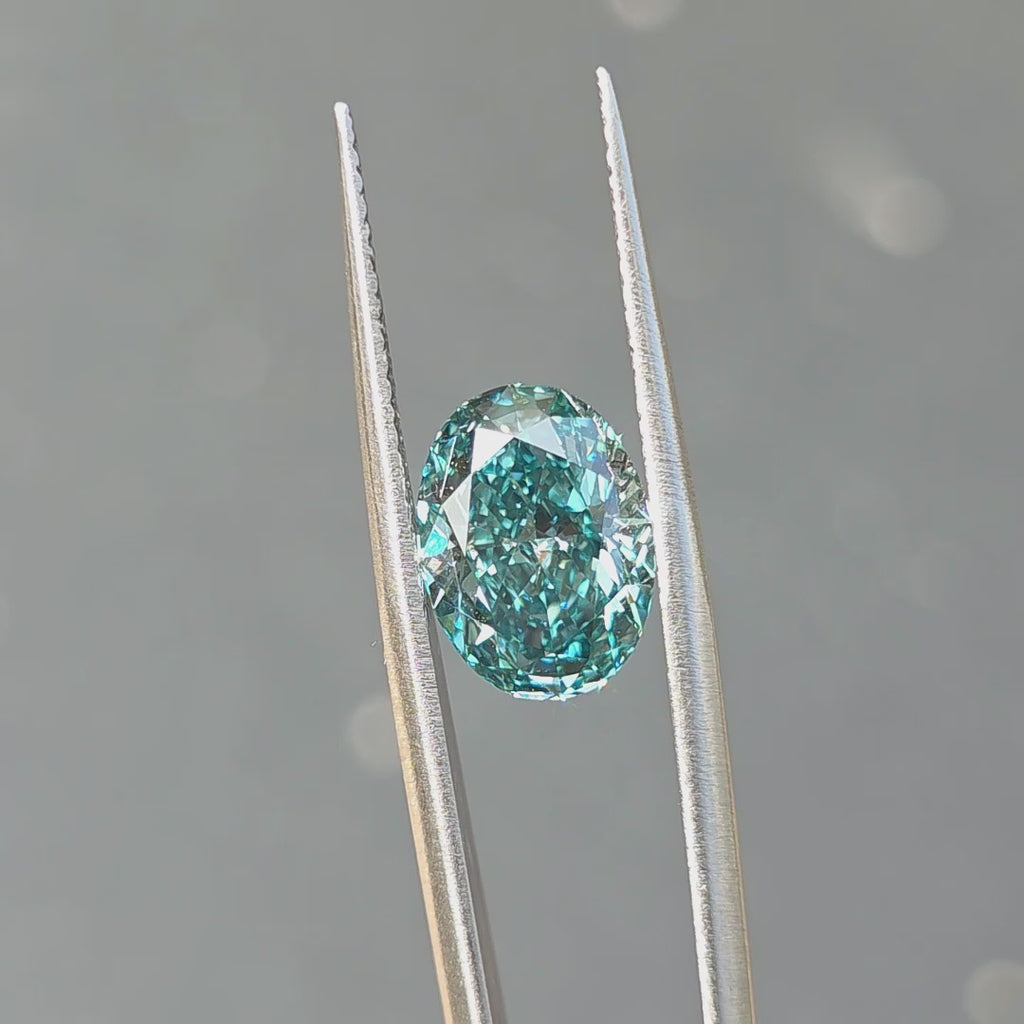 Outdoor sunlight reveals the brilliance of a 4.54ct oval brilliant cut fancy vivid blue VVS1 lab diamond.