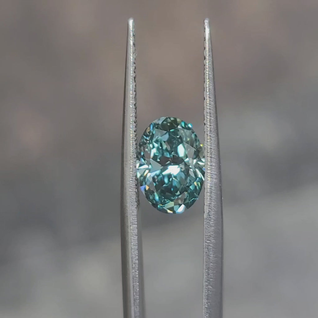 "Sunlight video showing 2.086ct oval cut fancy bluish green diamond's ocean-like color"