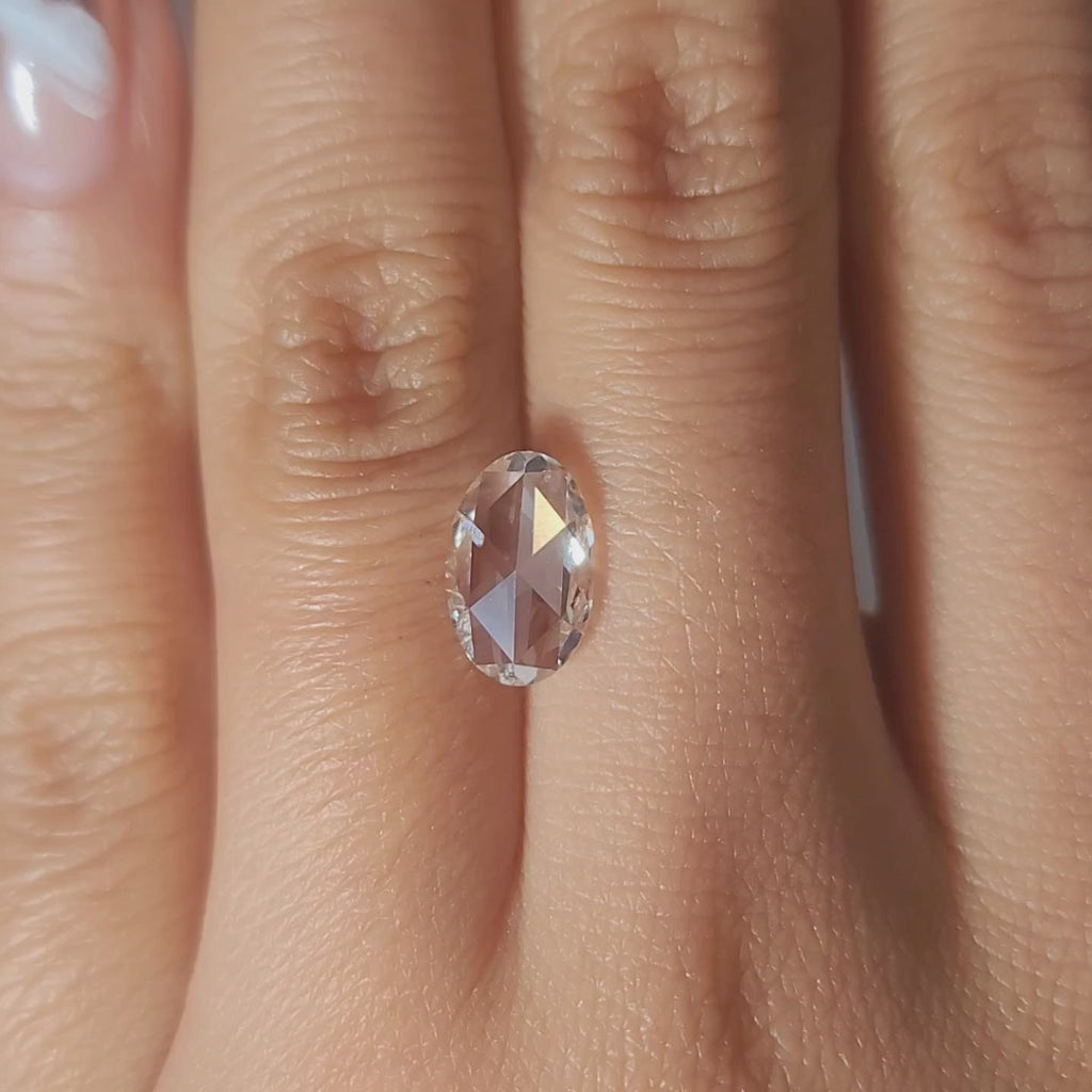1.73ct Oval F color VS1 diamond in warm handheld lighting