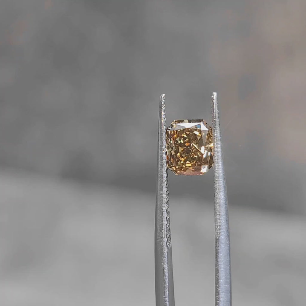 Sunlight video of 1.420ct radiant cut's rich coffee brown color and step faceting
