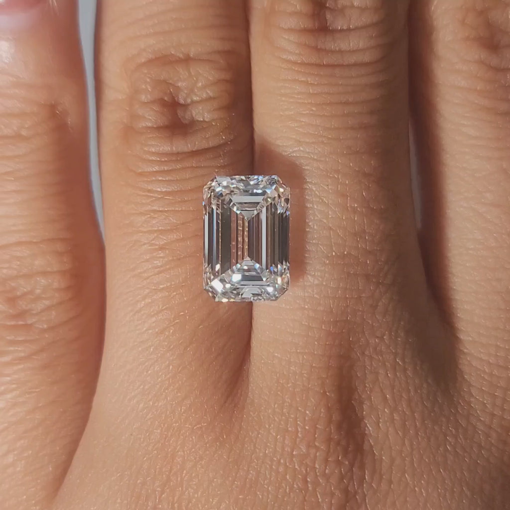 5.14ct emerald cut lab diamond on hand in warm light