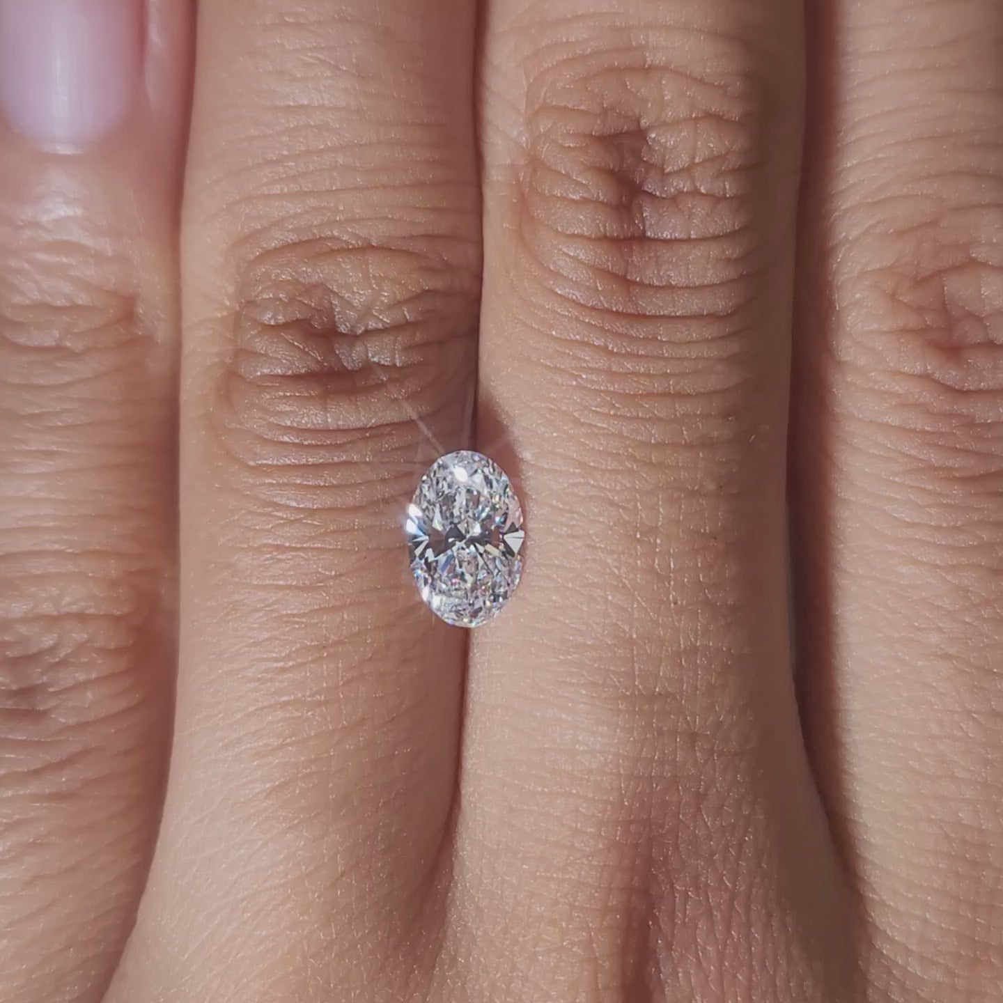 Hand-worn video of 1.03ct oval diamond in soft incandescent light