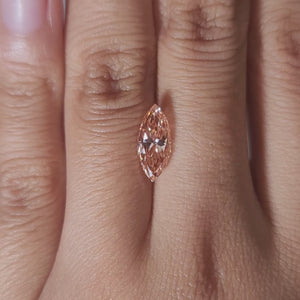 Close-up video of 2.03ct vivid pink marquise diamond under warm light