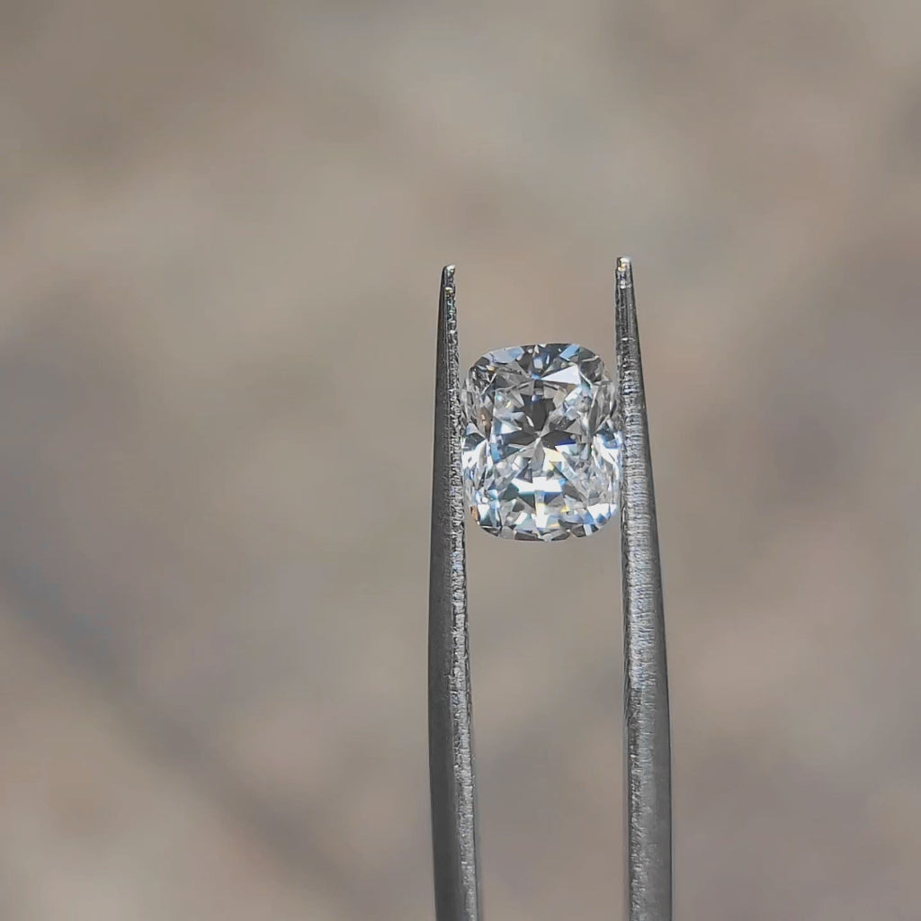 Daylight video showcasing 2.12ct cushion cut's D color puri