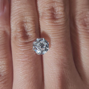 "Hand-modeled video of 2.103ct octagon diamond in warm indoor lighting"