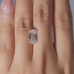 Close-up video of 3.12ct cushion cut diamond in warm light, emphasizing chunky faceting