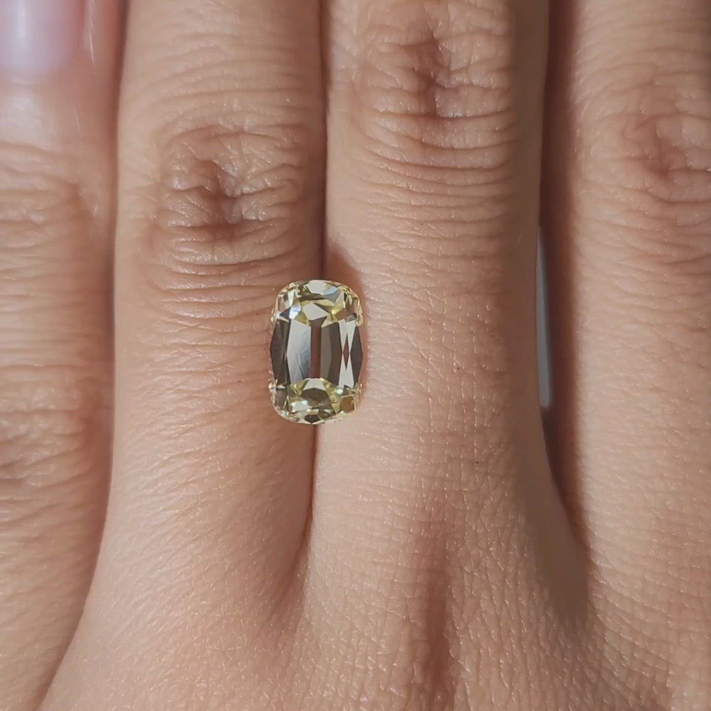 2.09ct Cushion yellow diamond in golden indoor lighting