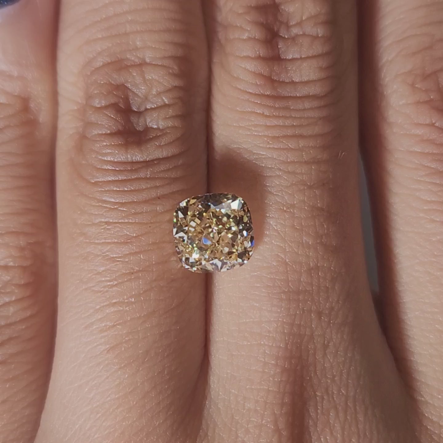 Hand-worn video showing 2.347ct yellow cushion diamond in warm home lighting