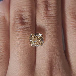 Hand-worn video showing 2.347ct yellow cushion diamond in warm home lighting