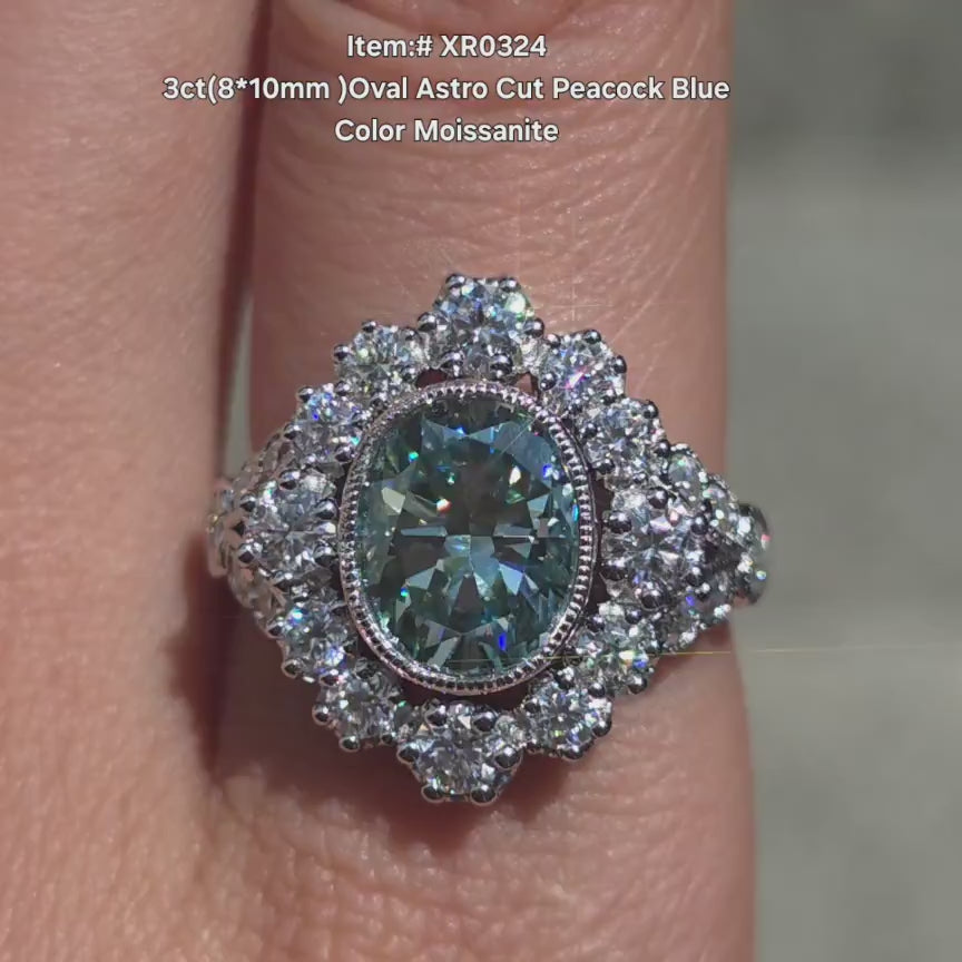 DovEggs oval floral peacock blue moissanite engagement ring in sunlight