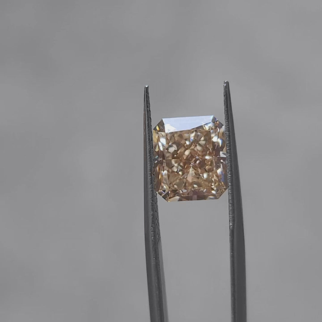 5.16ct radiant cut fancy vivid orange lab diamond sparkling in sunlight, showcasing intense color saturation