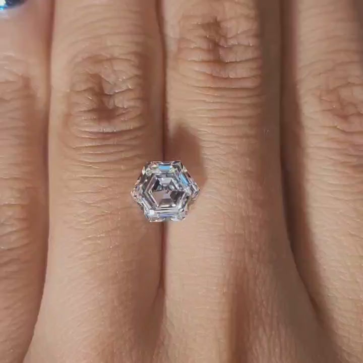 Finger-modeled video of 2.137ct hexagon diamond under warm indoor lights