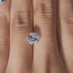 Finger-modeled video of 2.137ct hexagon diamond under warm indoor lights