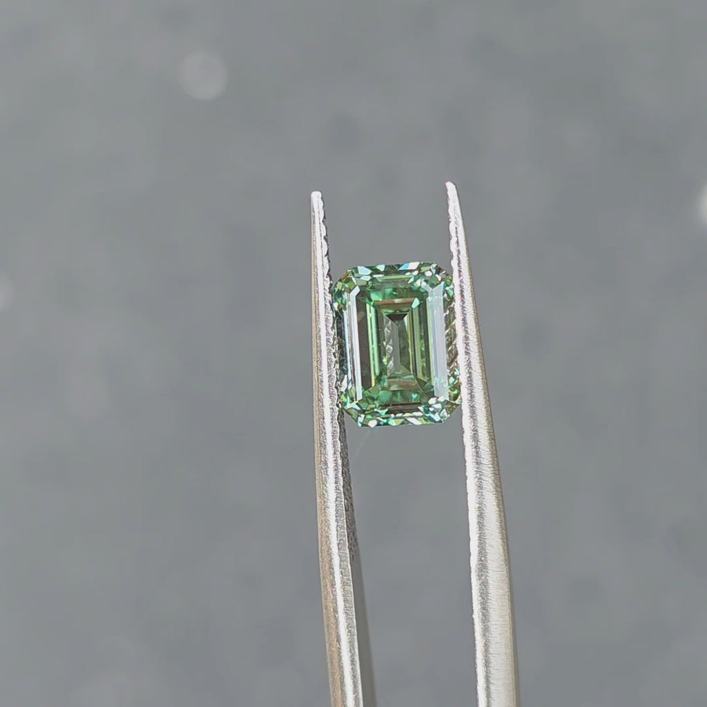 2.54ct emerald cut fancy vivid green VS1 lab diamond showing intense color in outdoor sunlight.