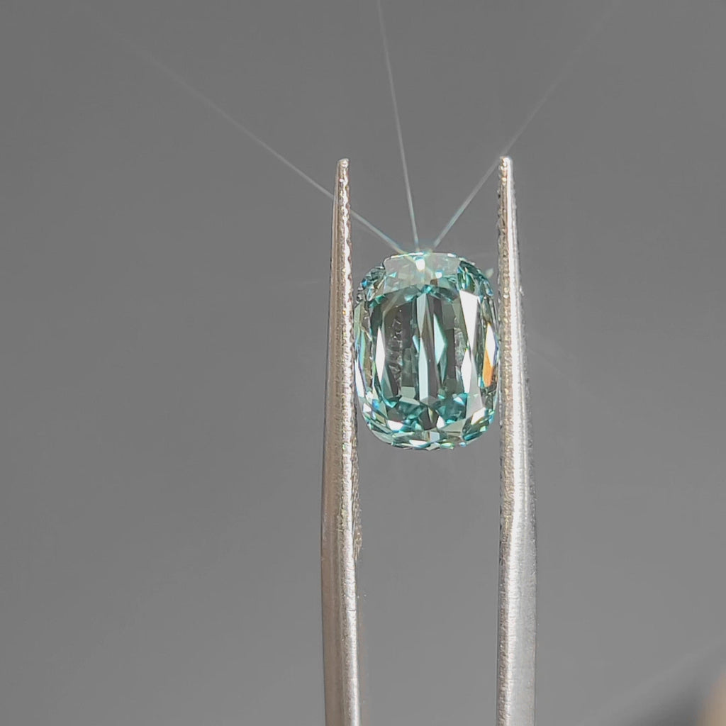 Daylight video emphasizing 3.002ct modified cushion's elongated shape and blue hue