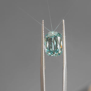 Daylight video emphasizing 3.002ct modified cushion's elongated shape and blue hue