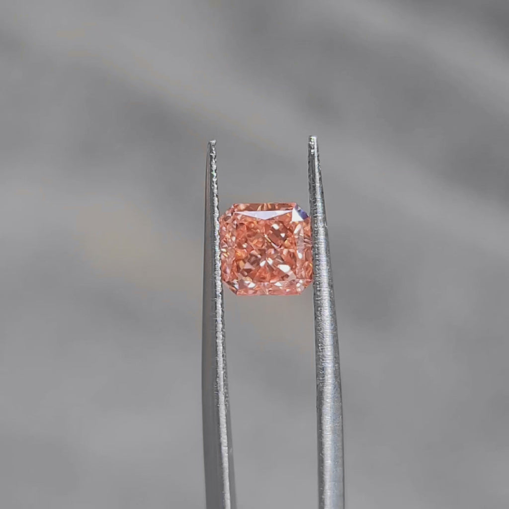 Outdoor video of 1.535ct radiant cut's pink-orange hue and fire dispersion