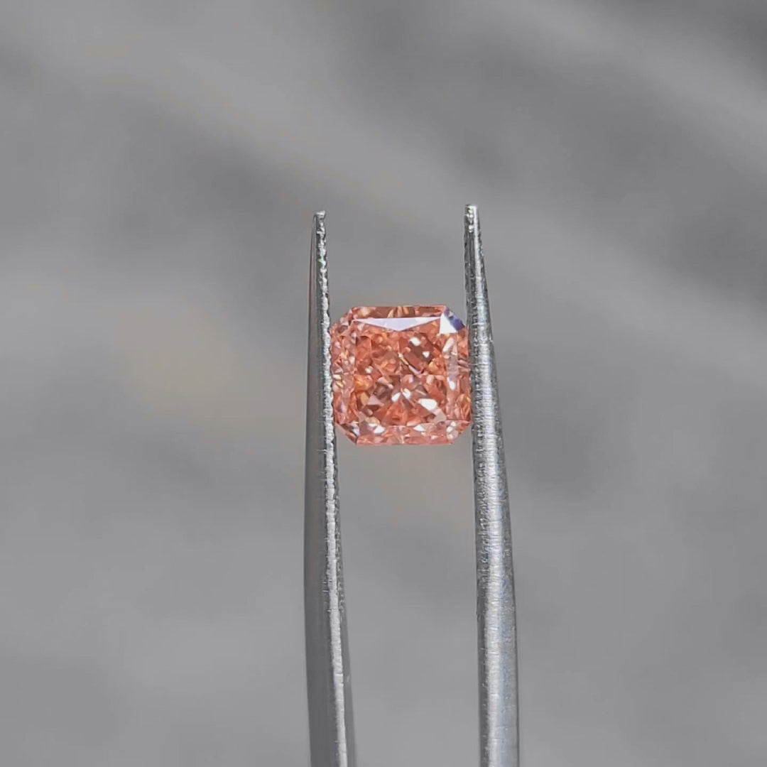 Outdoor video of 1.535ct radiant cut's pink-orange hue and fire dispersion