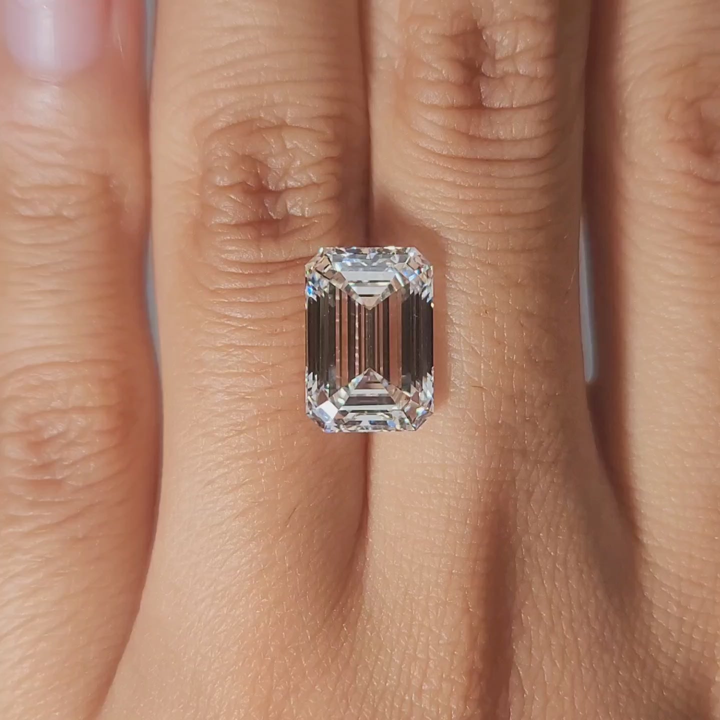 "Hand-worn video of 5.87ct emerald lab diamond in cozy indoor lighting"