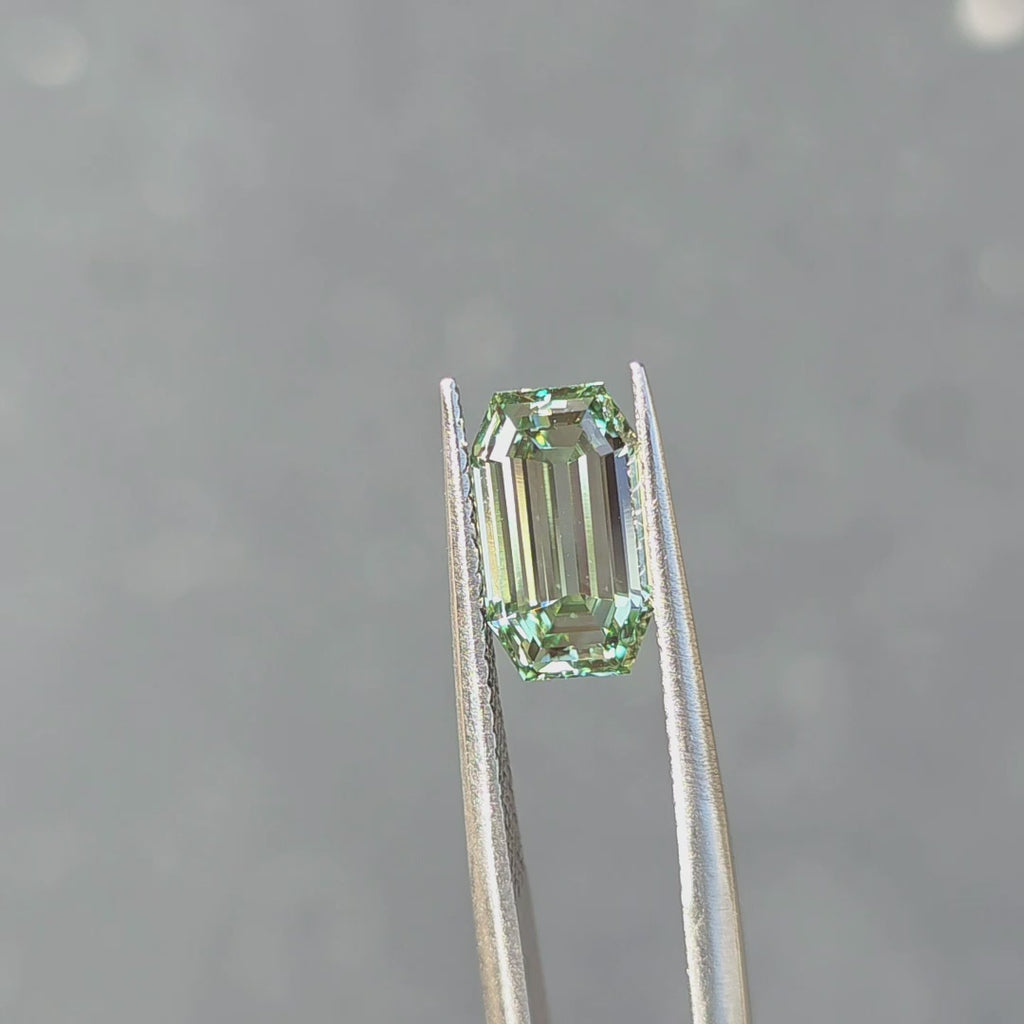 2.85ct old emerald cut fancy vivid green VVS1 lab diamond sparkling in outdoor sunlight.