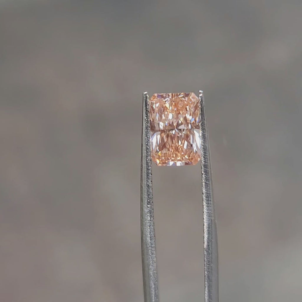 Sunlight video emphasizing 2.10ct radiant cut's pink hue depth