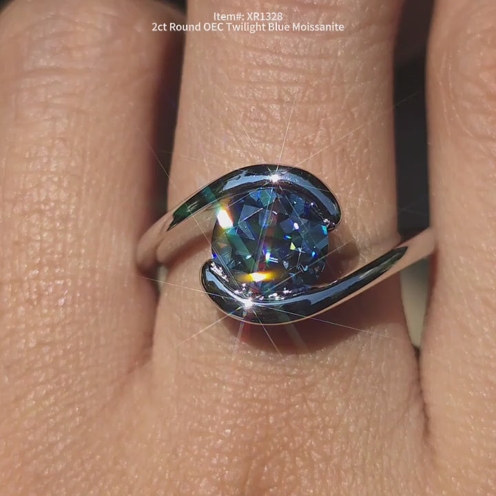  DovEggs round OEC twlight blue moissanite engagement ring sparkling in sunlight video