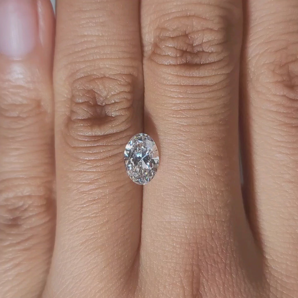 Hand-modeled video of 1.02ct oval lab diamond in warm interior light