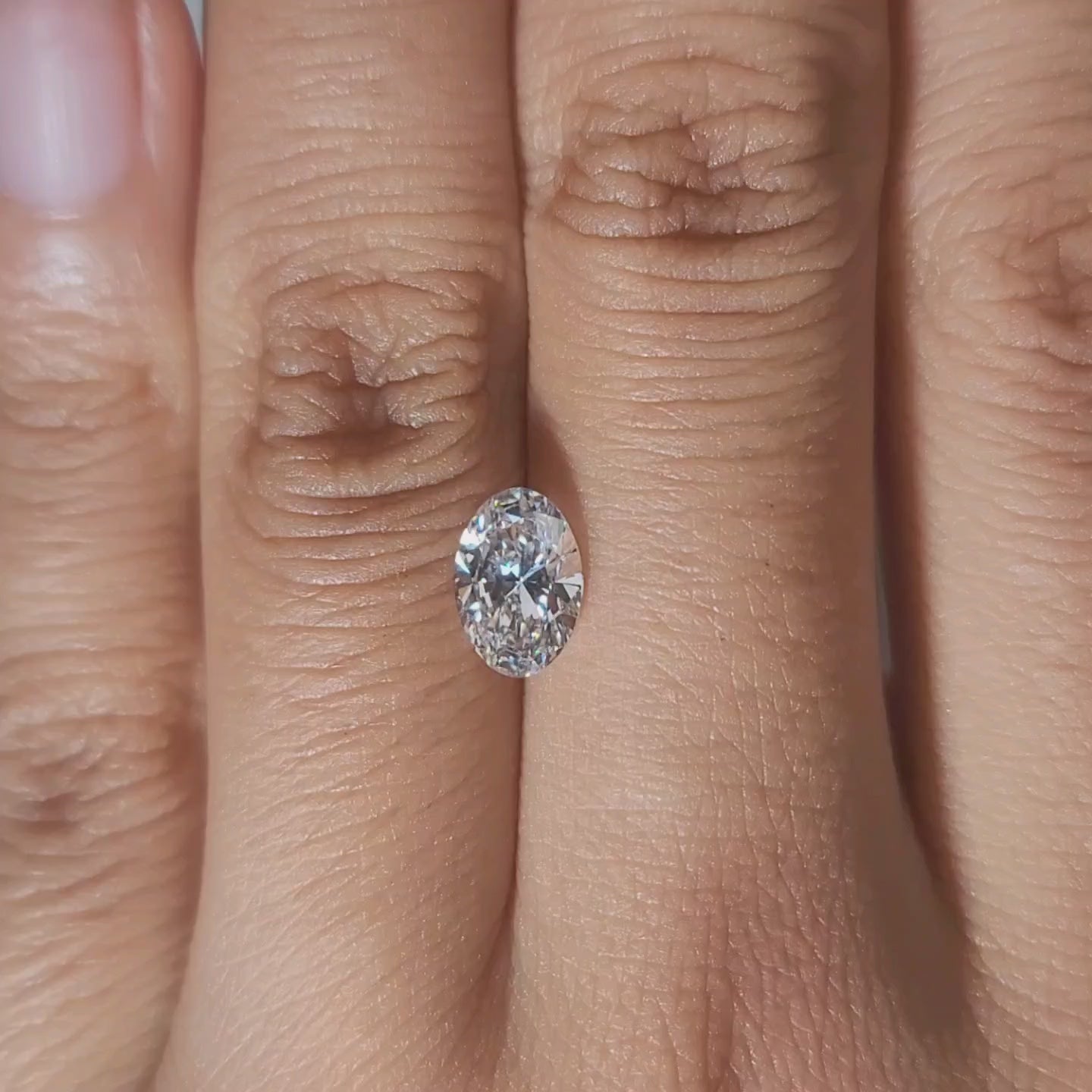 Hand-modeled video of 1.02ct oval lab diamond in warm interior light
