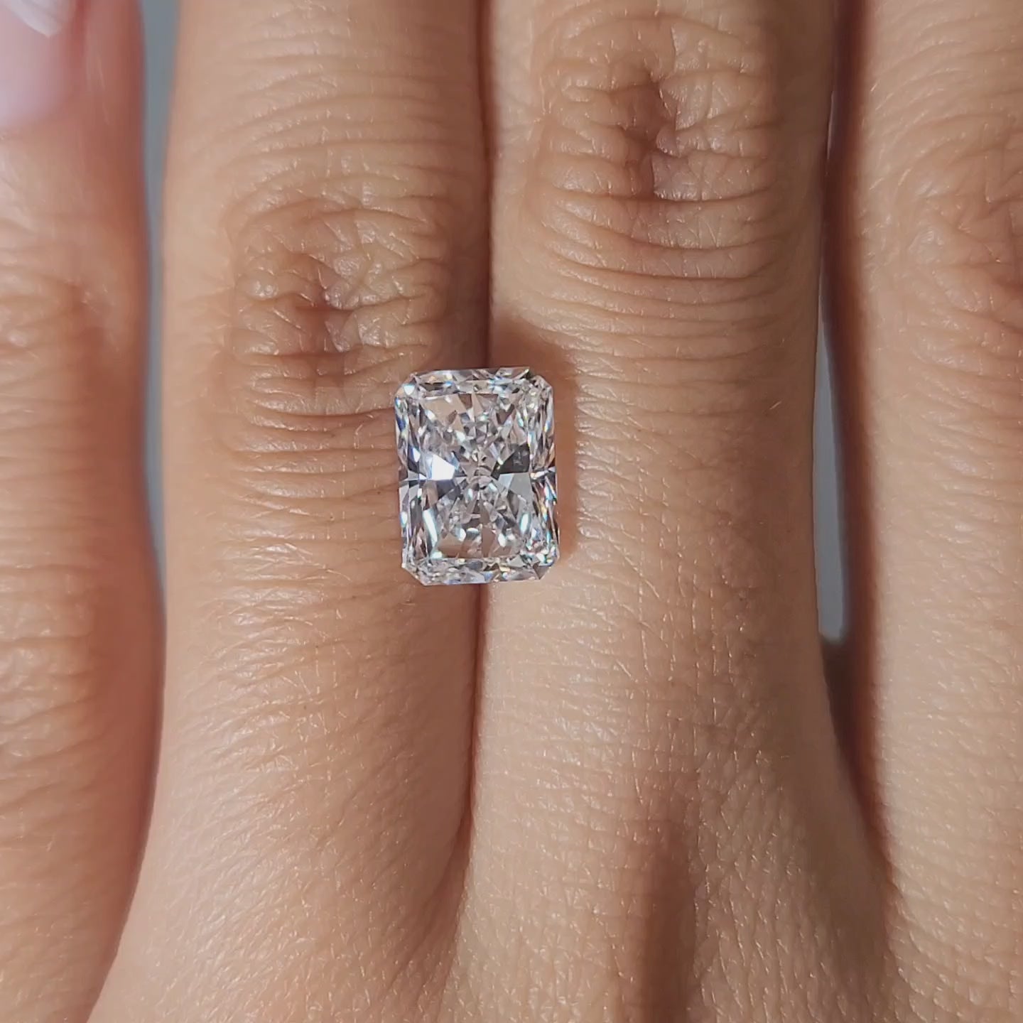 Hand-worn video of 3.03ct radiant diamond in warm glow