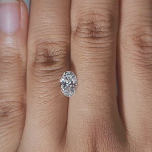 Close-up hand video of 1.03ct oval diamond in candlelight glow
