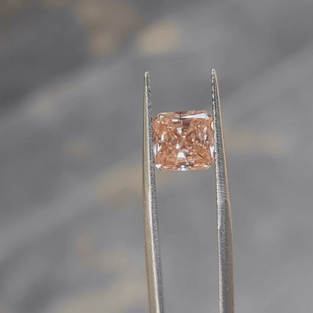 2.27ct radiant cut pink diamond's face-up size demonstration outdoors