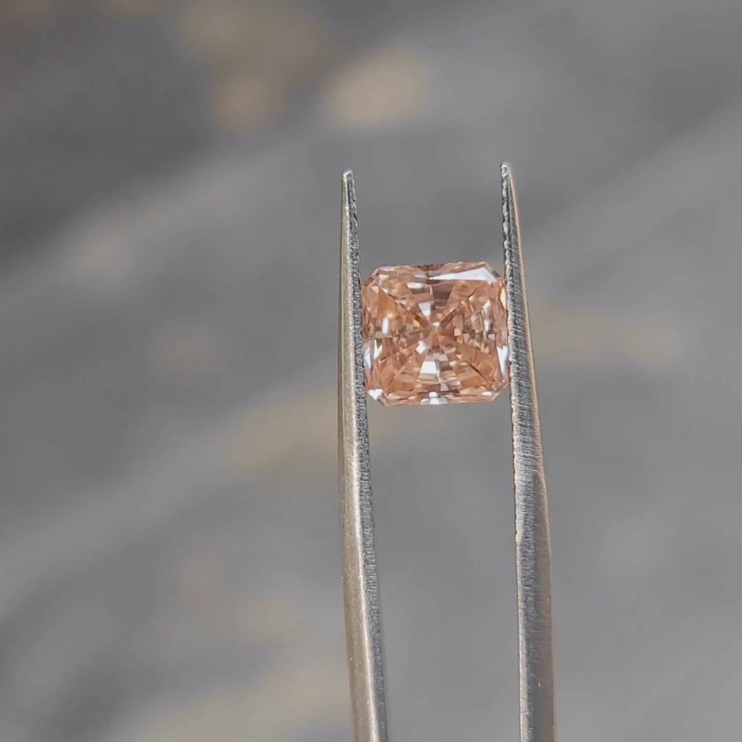 2.27ct radiant cut pink diamond's face-up size demonstration outdoors