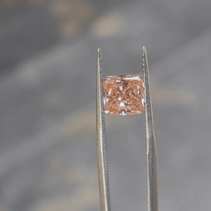 2.27ct radiant cut pink diamond's face-up size demonstration outdoors