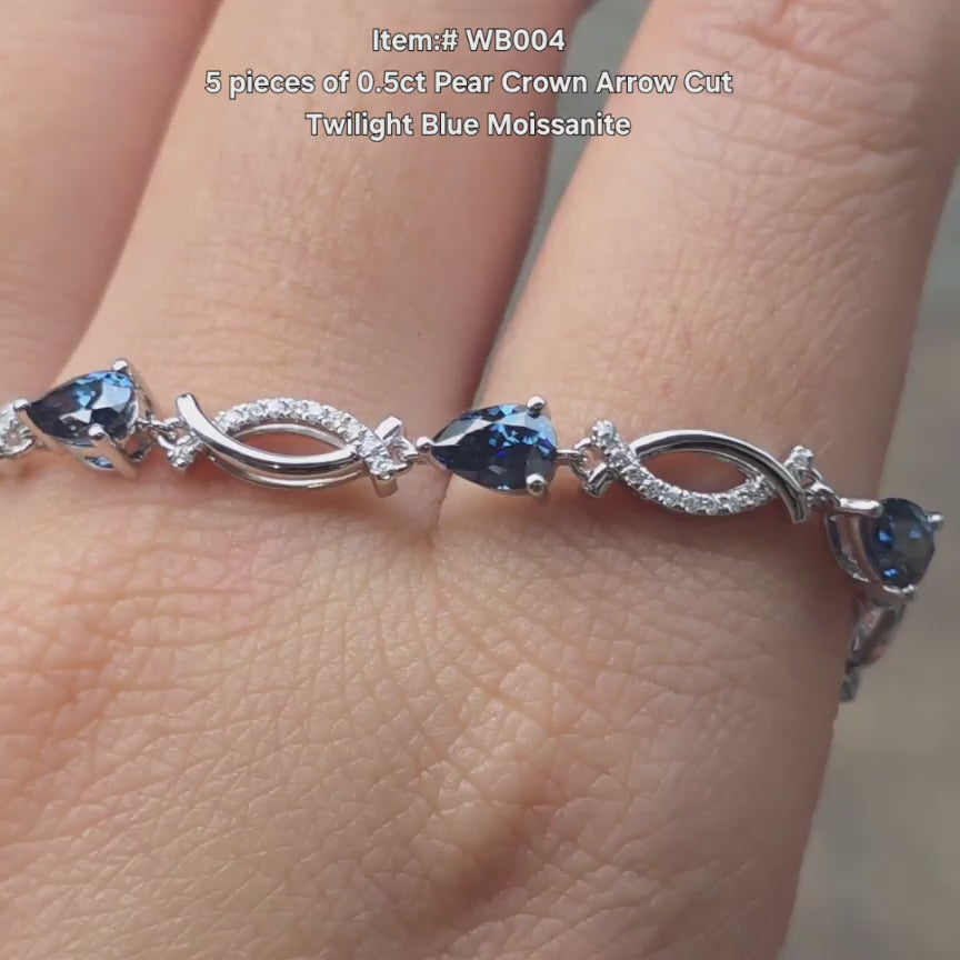 DovEggs Crown Arrow Pear twlight blue moissanite bracelet sparkling in sunlight video