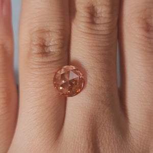 "Close-up hand video of 2.45ct pink rose cut diamond in candlelight"