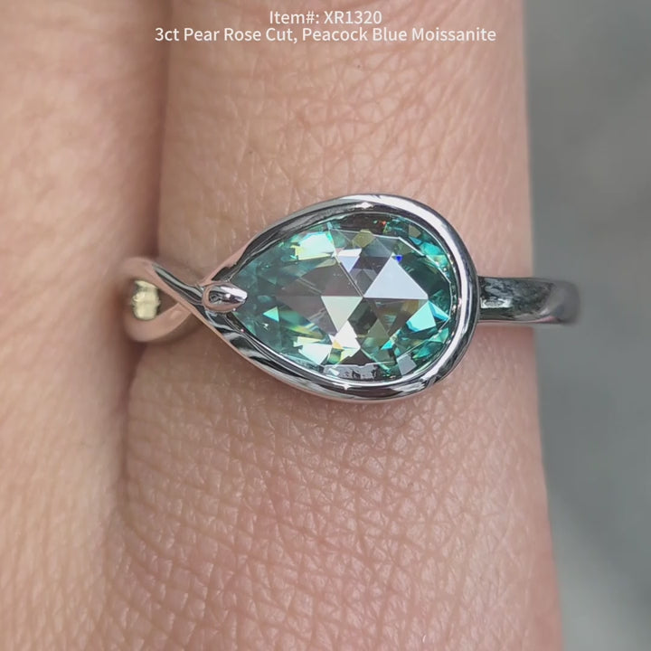 Pear rose cut peacock blue bezel moissanite ring sparkling in sunlight video.