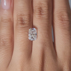"Finger-worn video of 2.46ct E color cushion diamond in warm candlelight"