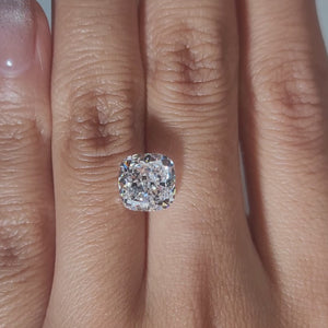"Hand-modeled video of 3.485ct cushion diamond in warm indoor lighting"