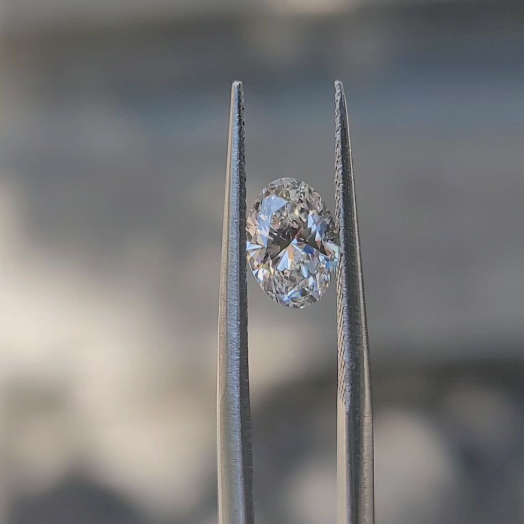 "Sunlight video showing 1.02ct oval cut diamond's F color sparkle"
