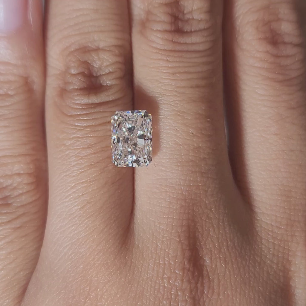 Close-up video of 3.07ct radiant cut diamond under warm indoor lighting, highlighting excellent cut and fire